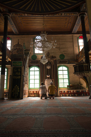 People praying at Camili Camii(mosque),a special mosque which was coverd with wooden boards built in Eighteen century.Artin,Macahel,Turkey,August 18, 2015のeditorial素材