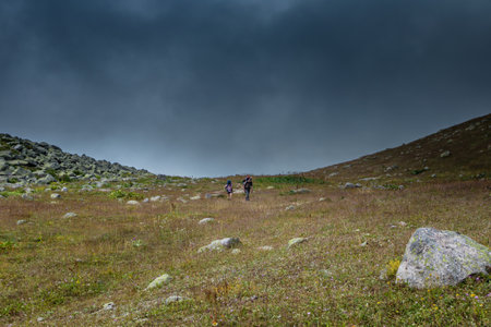Two unidentified hikers with large backpacks hiking on mountain Kackarlar. Kackar Mountains are a mountain range that rises above the Black Sea coast in eastern Turkeyのeditorial素材