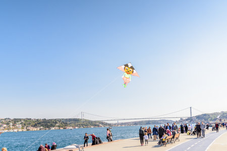 Colorful kite flying over bosphorus on blue sky in Istanbul,Turkey.15 April,2017のeditorial素材