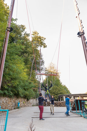 Unidentified man swinging on a machine for fun at Masukiye,a popular destination for locals and...