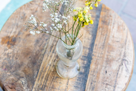 Soft retro view of flower vase on wood table ,Still-Life with unidentified flowers in glass vase...