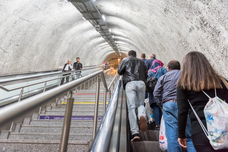 Unidentified People use escalator to access Metrobus, a part of public transportation system in...