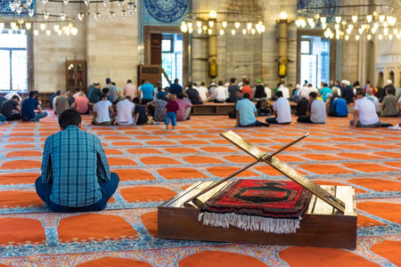 Unidentified Turkish Muslim men praying in Suleymaniye mosque.Old ancient Rahle (lectern) furniture...