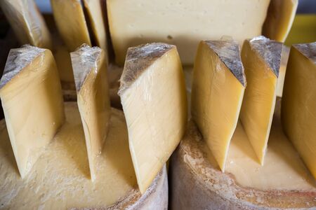 Traditional Old Sliced Turkish Kars cheddar cheese and cheese blocks are for sale on merchantの写真素材