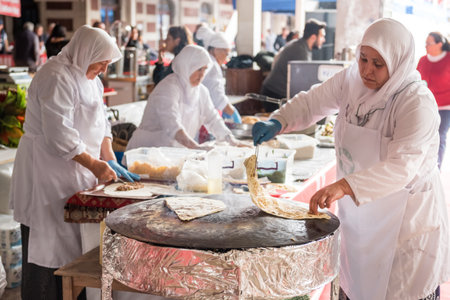 Unidentified woman cooking traditional Turkish food Gozleme,pastries or pancake, on the stove.Istanbul,Turkey,28 October 2017のeditorial素材