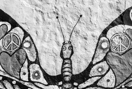 Peace symbol,heart shape and other different peace concepts painted over butterfly painting on grunge wallのeditorial素材