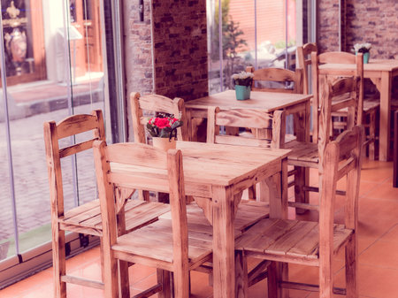 Retro, vintage view of Pastel coffee shop with wooden tables and chairs in Balat, old town of Istanbul, Turkey. Outdoor cafe. Photo in vintage image style.ISTANBUL, TURKEYの写真素材