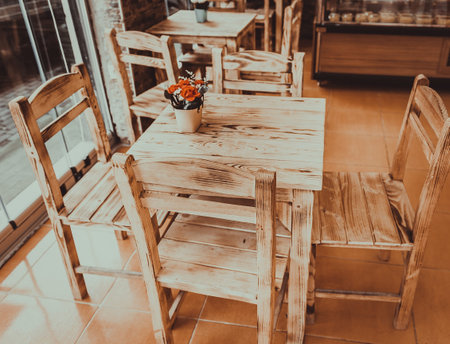 Retro, vintage view of Pastel coffee shop with wooden tables and chairs in Balat, old town of...