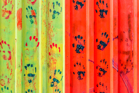 colored hand prints on Metal rustic plate.Texture surface,wall background.の写真素材