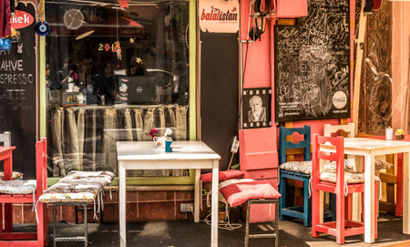 Retro, vintage view of Pastel coffee shop with wooden tables and chairs in Balat, old town of Istanbul, Turkey. Outdoor cafe. Photo in vintage image style.ISTANBUL, TURKEY - May 6, 2017のeditorial素材