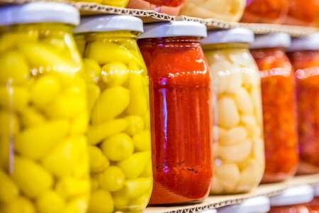 Store shelves with Various pickles in glass jar display for saleの写真素材