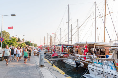 Unidentified people walk along shore in Bodrum with blue sky.Bodrum,Turkey.23 August 2017.のeditorial素材