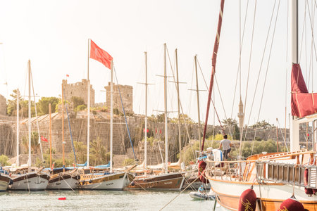 View of Castle of St. Peter,Bodrum Castle and Marine with luxury yachts and sail yachts in Bodrum harbor.Bodrum,Turkey.23 August 2017.のeditorial素材