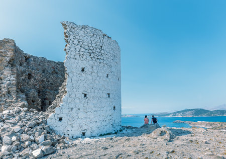 People sit near Traditional restored windmills on top of Bodrum hill overlooking Bodrum and Gumbet.23 August 2017.のeditorial素材