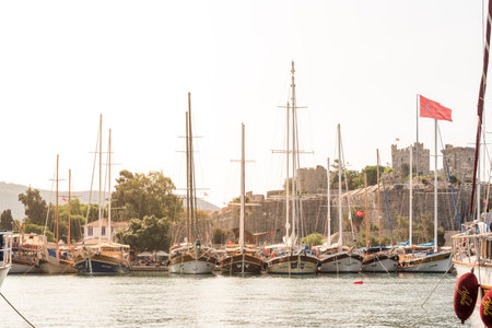 View of Castle of St. Peter,Bodrum Castle and Marine with luxury yachts and sail yachts in Bodrum harbor.Bodrum,Turkey.23 August 2017.のeditorial素材