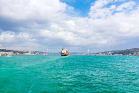Huge Cargo ship tanker or container passes under 15 July Martyrs Bridge in bosphorus channel ,Istanbul, Turkey.03 January 2018のeditorial素材