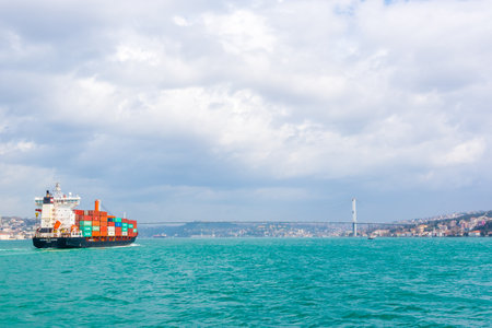 Huge Cargo ship tanker or container passes under 15 July Martyrs Bridge in bosphorus channel ,Istanbul, Turkey.03 January 2018のeditorial素材