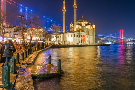 Exterior view of Ortakoy Mosque with15 July Martyrs Bridge or unofficially Bosphorus Bridge also called First Bridge over bosphorus in Istanbul,Turkey.03 January 2018のeditorial素材