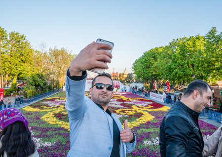 21 April 2018 :- Unidentified people take pictures of Largest Carpet of Tulips of the World in Sultanahmet for tulip festival in Istanbul,Turkey.のeditorial素材