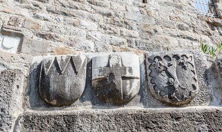 Cross and other signs carved into the wall of ancient Roman marble sculpture in Castle of St. Peter or Bodrum Castle, Turkey.の写真素材