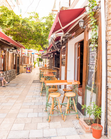 Narrow streets of Bodrum  with cafe table and chairs  inBodrum,Turkey.23 August 2017.のeditorial素材