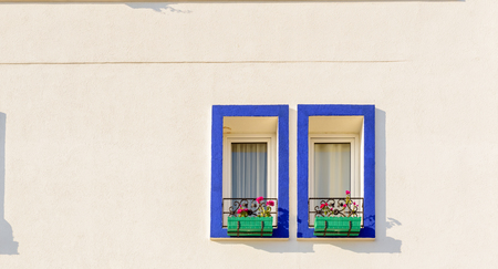 View of blue window with white stone wall background in Bodrum,Turkey.の写真素材