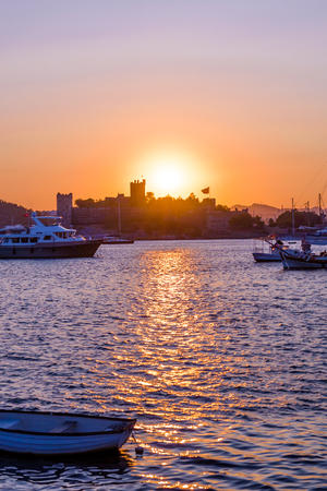 Sunset view of  Bodrum Marine with yachts and  St. Peter Castle or Bodrum Castle on background in Bodrum, Turkey.の写真素材