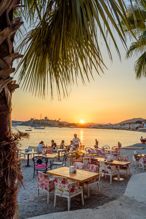 Unidentified people enjoy at beach cafe and Sunset view of  Bodrum Marine with yachts and  St. Peter Castle or Bodrum Castle view in Bodrum, Turkey.23 August 2017のeditorial素材
