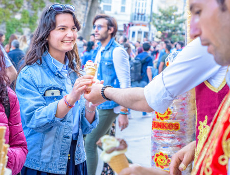 Ice cream seller man dressed in traditional Turkish costume plays a traditional Turkish joke with...