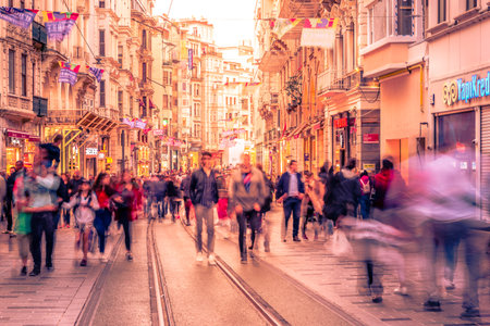 Long exposure or slow shutter speed and blurred image:Unidentified people walk at Istiklal...