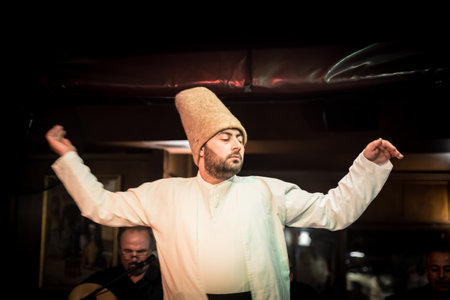 Unidentified Turkish dervish man performs Mevlevi,Sama Ceremony for a show at cafe in Istanbul,Turkey.05 May 2018のeditorial素材