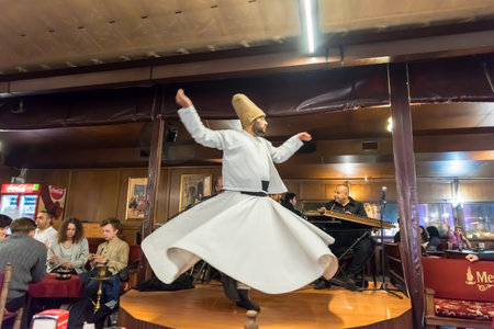 Unidentified Turkish dervish man performs Mevlevi,Sama Ceremony for a show at cafe in Istanbul,Turkey.05 May 2018のeditorial素材