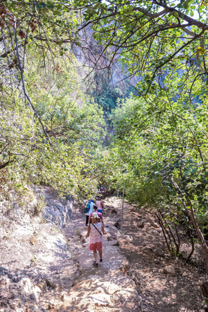 Unidentified people going down to stone slippery stairs towards cave of Chasm of Heaven in Silifke district, Mersin Turkey.29 August 2017.のeditorial素材