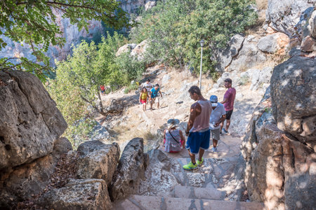 Unidentified people going down to stone slippery stairs towards cave of Chasm of Heaven in Silifke district, Mersin Turkey.29 August 2017.のeditorial素材