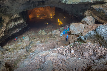 Unidentified people going down to stone slippery stairs towards cave of Chasm of Heaven in Silifke district, Mersin Turkey.29 August 2017.のeditorial素材