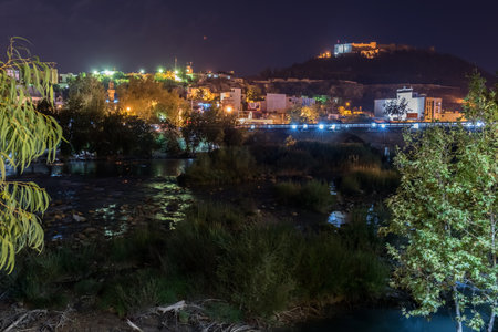 View of Silifke town with goksu river, Silifke stone bridge and castle in evening.のeditorial素材