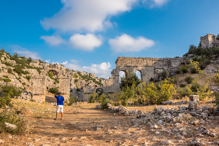 Unidentified man visiting and exploring Olba Ancient city located in Uzuncaburc,Silifke,Mersin,Turkey.の写真素材