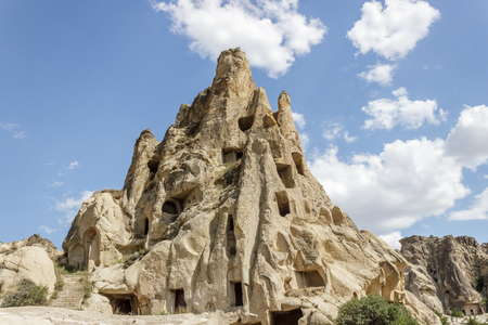 Fairy tale chimneys in Cappadocia with blue sky on background in Goreme,Nevsehir, Turkeyの写真素材