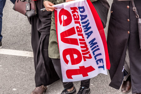 AKP (Justice and Development Party) supporters shout slogans and wave party flags during a yes referendum,plebiscite campaign rally in Istanbul, Yenikapi meeting area.TURKEY, ISTANBUL, APRIL 8, 2017のeditorial素材