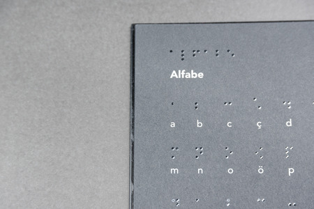 Top view of black page of a book written in braille alphabet for blind people.Copy space for editingの写真素材