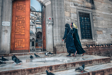 People walking on stairs of New mosque on a snowy day in winter.Istanbul,Turkey,18,January 2016のeditorial素材