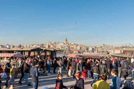 ISTANBUL, TURKEY - MARCH 5, 2017:Eminonu Square, tourists and local people are traveling,shopping, fishing and eating fish.Eminonu Square is so crowded everyday with lots of Tourists and local people.のeditorial素材
