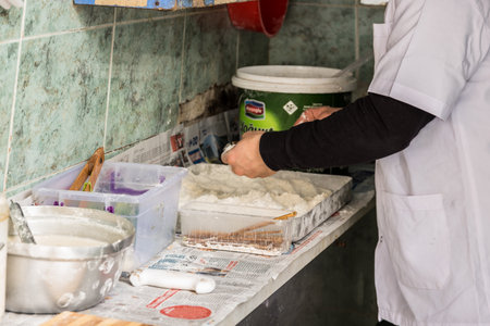 Preparing Turkish style chopped mussels (Midye tava) fried in deep oil  in a special pan on the Street in Istanbul, Turkey.のeditorial素材