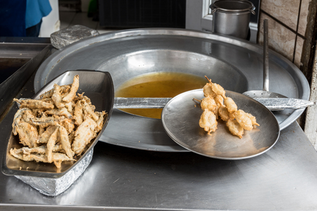 Turkish style chopped mussels (Midye tava) fried in deep oil  in a special pan on the Street in Istanbul, Turkey.の写真素材