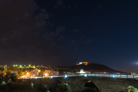 View of Silifke town with Silifke stone bridge and castle in evening.のeditorial素材