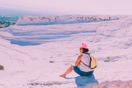 Unidentified woman poses for a camera at Pamukkale (Cotton Castle) that is popular with Travertine pools and terraces  where people love to visit in Pamukkale,Turkey.25 August,2017のeditorial素材