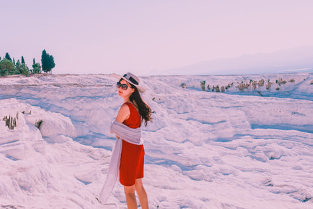 Unidentified woman poses for a camera at Pamukkale (Cotton Castle) that is popular with Travertine pools and terraces  where people love to visit in Pamukkale,Turkey.25 August,2017のeditorial素材