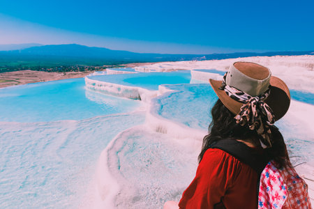 Unidentified woman watch Pamukkale (Cotton Castle) that is popular with Travertine pools and terraces  where people love to visit in Pamukkale, Turkey.のeditorial素材