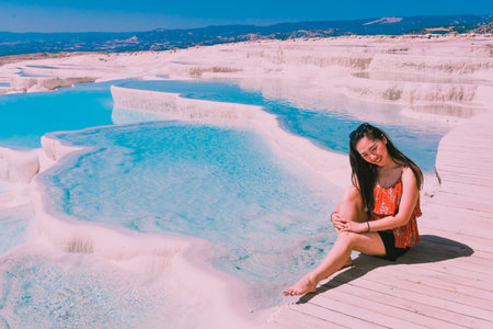Unidentified woman poses for a camera at Pamukkale (Cotton Castle) that is popular with Travertine pools and terraces  where people love to visit in Pamukkale, Turkey.25 August,2017のeditorial素材