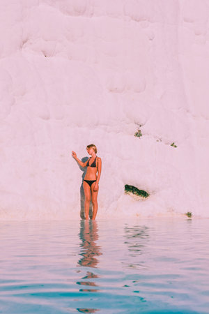 Unidentified woman poses for a camera at Pamukkale (Cotton Castle) that is popular with Travertine pools and terraces  where people love to visit in Pamukkale,Turkey.25 August,2017のeditorial素材
